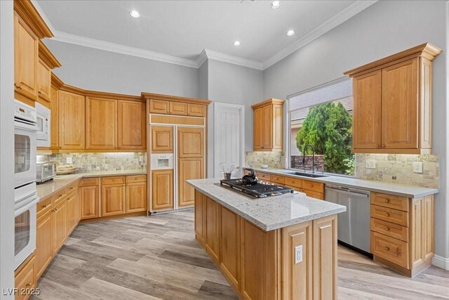 108 Valiente St, Las Vegas, NV 89144 - kitchen with appliances with stainless steel finishes, a center island, crown molding, backsplash, and recessed lighting