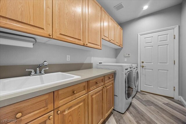 108 Valiente St, Las Vegas, NV 89144 - laundry room featuring cabinet space, light wood-style flooring, washing machine and dryer, and recessed lighting