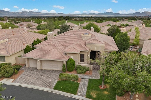 108 Valiente St, Las Vegas, NV 89144 - view of front of home with a tile roof, an attached garage, stucco siding, and a chimney