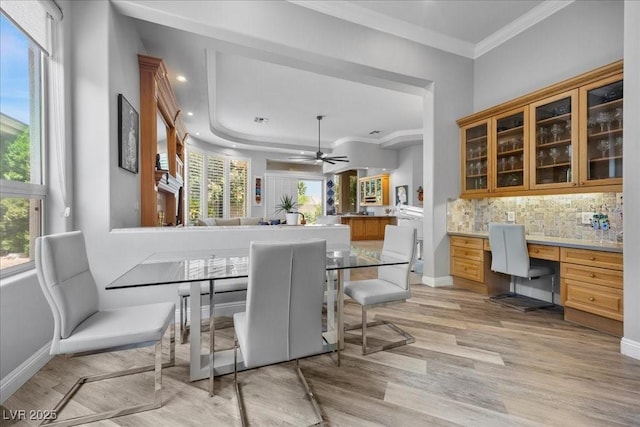 108 Valiente St, Las Vegas, NV 89144 - dining area with light wood-type flooring, built in study area, ornamental molding, and plenty of natural light