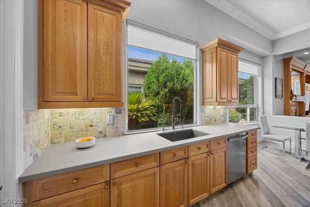 108 Valiente St, Las Vegas, NV 89144 - kitchen with stainless steel dishwasher, ornamental molding, light wood finished floors, light countertops, and healthy amount of natural light