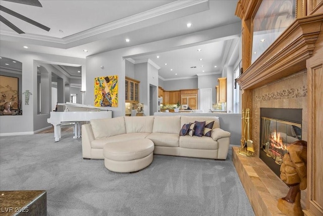 108 Valiente St, Las Vegas, NV 89144 - living room featuring light carpet, recessed lighting, crown molding, and a glass covered fireplace