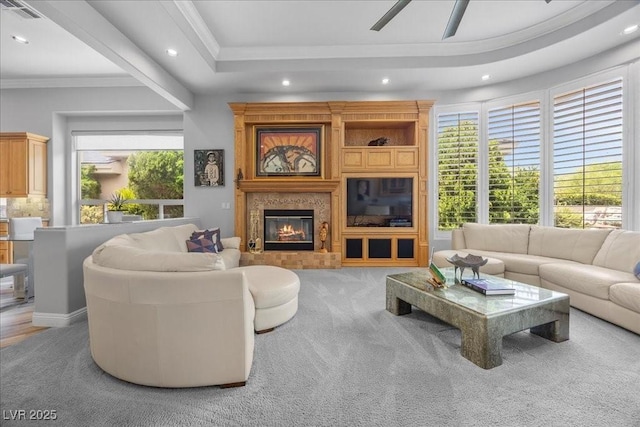 108 Valiente St, Las Vegas, NV 89144 - carpeted living area with recessed lighting, ornamental molding, a glass covered fireplace, ceiling fan, and a tray ceiling