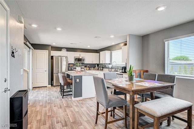 5617 Craftsman Ave, Las Vegas, NV 89122 - dining area with light wood-style flooring and recessed lighting