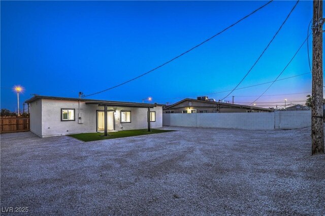 5200 Blanton Dr, Las Vegas, NV 89122 - back of house at dusk featuring stucco siding