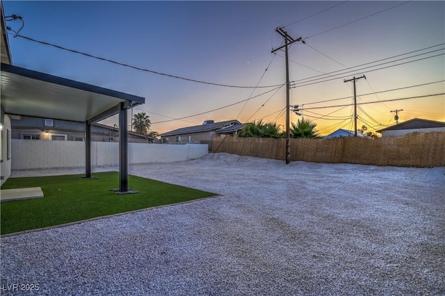 5200 Blanton Dr, Las Vegas, NV 89122 - yard at dusk featuring a fenced backyard and a patio
