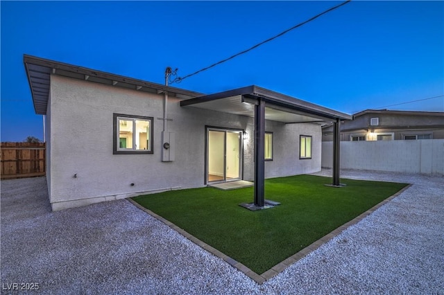 5200 Blanton Dr, Las Vegas, NV 89122 - back of property featuring a fenced backyard, a patio area, and stucco siding