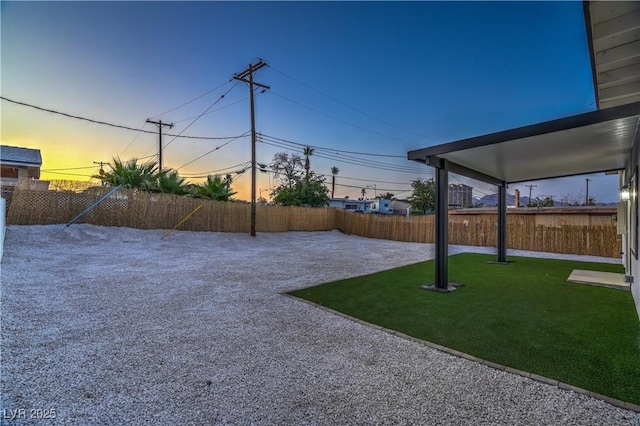 5200 Blanton Dr, Las Vegas, NV 89122 - yard at dusk with a fenced backyard and a patio area