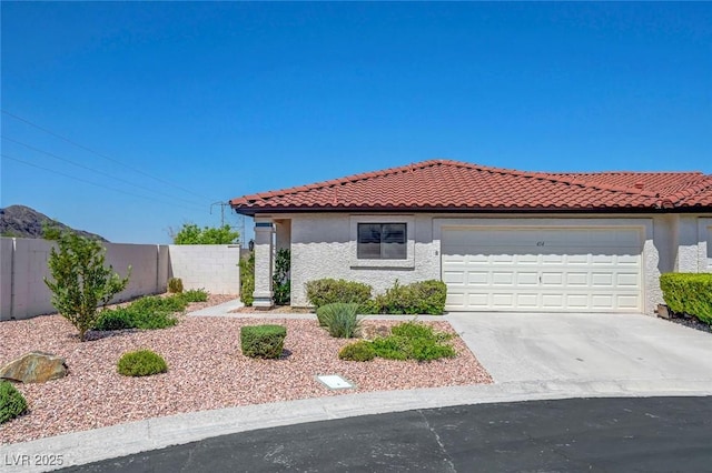 454 Intrepid Ct, Boulder City, NV 89005 - mediterranean / spanish-style house with a garage, concrete driveway, stucco siding, and a tile roof