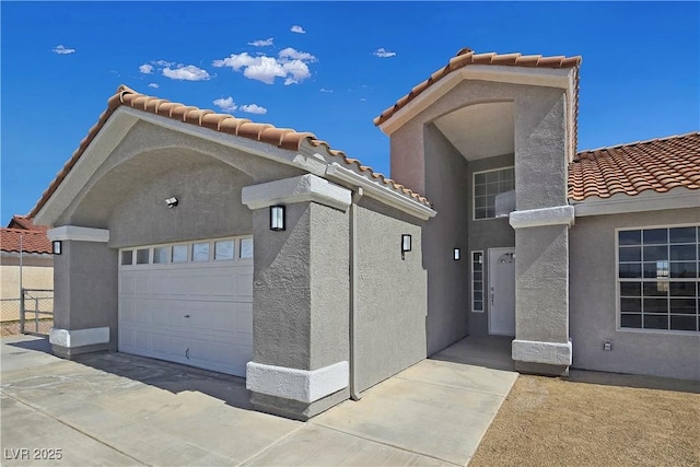 3326 Mount Charleston Dr, Pahrump, NV 89048 - view of front of home featuring a tiled roof, a garage, and stucco siding