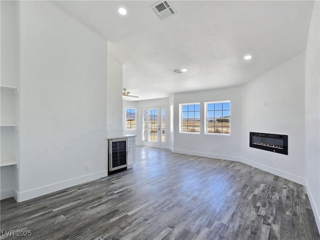 3326 Mount Charleston Dr, Pahrump, NV 89048 - unfurnished living room with a glass covered fireplace, wine cooler, wood finished floors, recessed lighting, and a ceiling fan