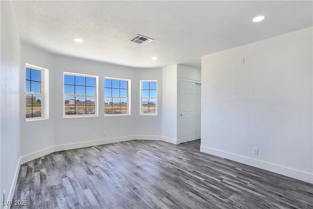 3326 Mount Charleston Dr, Pahrump, NV 89048 - empty room featuring dark wood-style floors, recessed lighting, and a textured ceiling