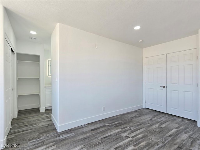 3326 Mount Charleston Dr, Pahrump, NV 89048 - unfurnished bedroom featuring dark wood finished floors, a closet, recessed lighting, and a textured ceiling