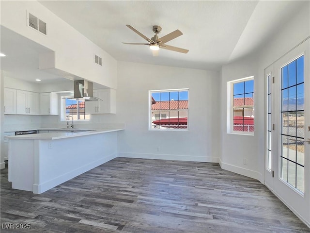 3326 Mount Charleston Dr, Pahrump, NV 89048 - kitchen featuring exhaust hood, lofted ceiling, light countertops, white cabinetry, and dark wood-style floors