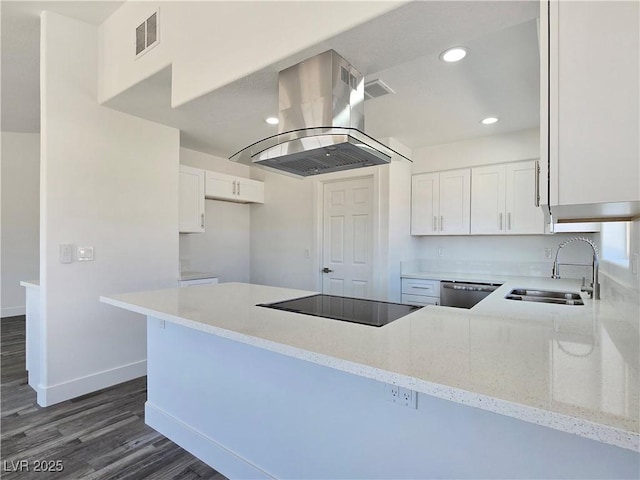 3326 Mount Charleston Dr, Pahrump, NV 89048 - kitchen with island exhaust hood, black electric cooktop, light stone countertops, white cabinetry, and dark wood-type flooring