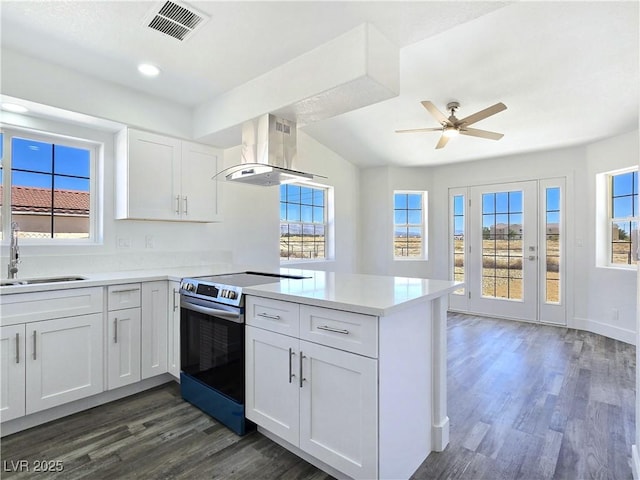 3326 Mount Charleston Dr, Pahrump, NV 89048 - kitchen featuring electric stove, island exhaust hood, a peninsula, dark wood-style floors, and recessed lighting