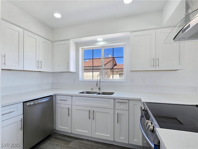 3326 Mount Charleston Dr, Pahrump, NV 89048 - kitchen featuring appliances with stainless steel finishes, ventilation hood, white cabinets, light countertops, and recessed lighting