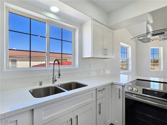 3326 Mount Charleston Dr, Pahrump, NV 89048 - kitchen featuring electric stove, wall chimney range hood, white cabinets, light stone counters, and recessed lighting