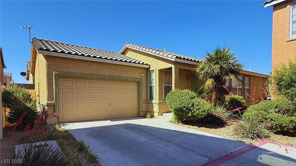 2613 Calico Hearts Ct, Las Vegas, NV 89106 - ranch-style house with driveway, a garage, stucco siding, and a tile roof
