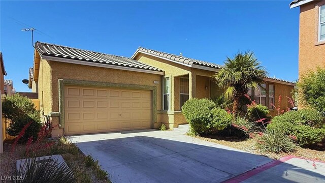 2613 Calico Hearts Ct, Las Vegas, NV 89106 - ranch-style house with driveway, a garage, stucco siding, and a tile roof