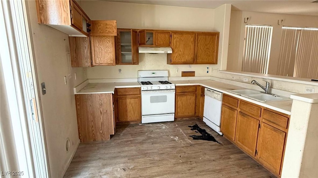 2613 Calico Hearts Ct, Las Vegas, NV 89106 - kitchen featuring white appliances, under cabinet range hood, brown cabinetry, wood finished floors, and a peninsula