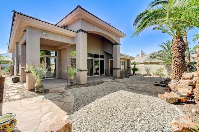 536 Pima Canyon Ct, Las Vegas, NV 89144 - rear view of house with stucco siding and a patio area