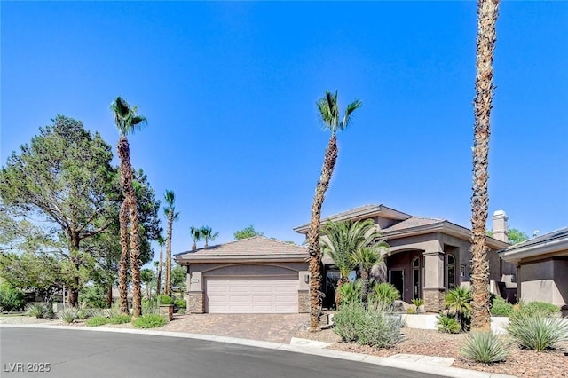 536 Pima Canyon Ct, Las Vegas, NV 89144 - view of front of house featuring stucco siding, driveway, an attached garage, and stone siding