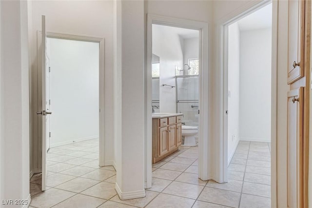536 Pima Canyon Ct, Las Vegas, NV 89144 - corridor with light tile patterned flooring and a sink