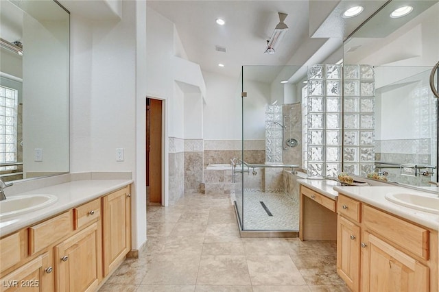 536 Pima Canyon Ct, Las Vegas, NV 89144 - bathroom with two vanities, a shower stall, tile patterned flooring, a garden tub, and recessed lighting