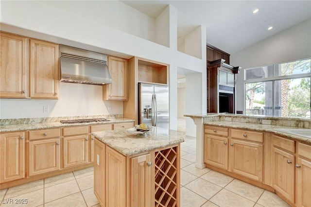 536 Pima Canyon Ct, Las Vegas, NV 89144 - kitchen with stainless steel appliances, light brown cabinetry, ventilation hood, light tile patterned floors, and high vaulted ceiling