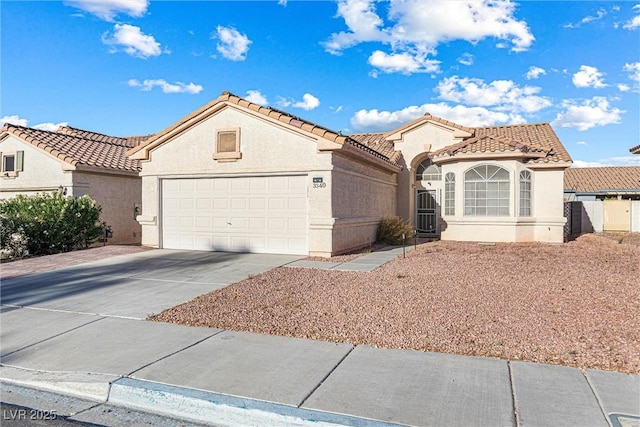 3340 N Campbell Rd, Las Vegas, NV 89129 - mediterranean / spanish-style house featuring a garage, driveway, stucco siding, and a tiled roof