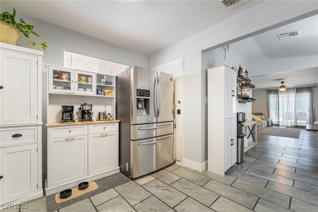 405 Box Elder Way, Henderson, NV 89015 - kitchen with stainless steel fridge, white cabinetry, open floor plan, glass insert cabinets, and ceiling fan