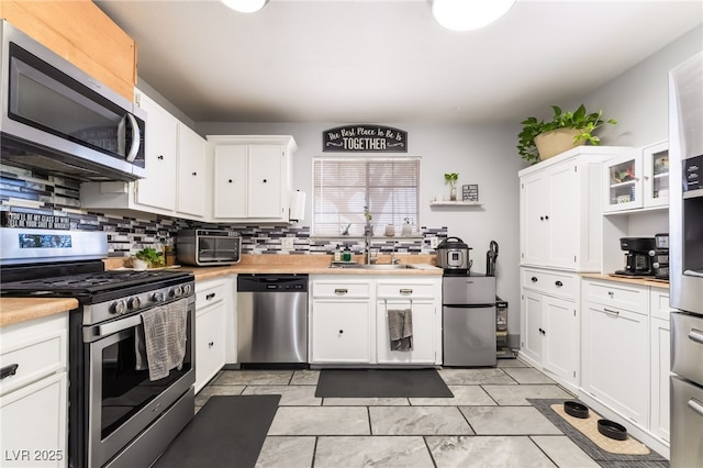 405 Box Elder Way, Henderson, NV 89015 - kitchen with appliances with stainless steel finishes, light countertops, white cabinetry, and backsplash