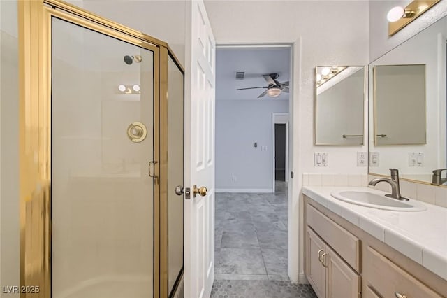 5425 Comchec Way Unit 103, Las Vegas, NV 89108 - full bath featuring a stall shower, ceiling fan, vanity, and tile patterned floors