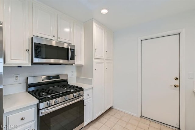 5425 Comchec Way Unit 103, Las Vegas, NV 89108 - kitchen featuring appliances with stainless steel finishes, light countertops, white cabinets, recessed lighting, and light tile patterned floors