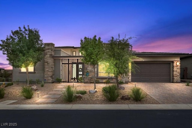 6804 Regency Stone Way, Las Vegas, NV 89148 - view of front facade with a garage, decorative driveway, stucco siding, and stone siding
