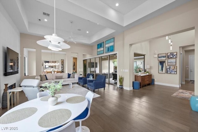 6804 Regency Stone Way, Las Vegas, NV 89148 - dining space featuring ceiling fan, wood finished floors, a towering ceiling, recessed lighting, and a raised ceiling