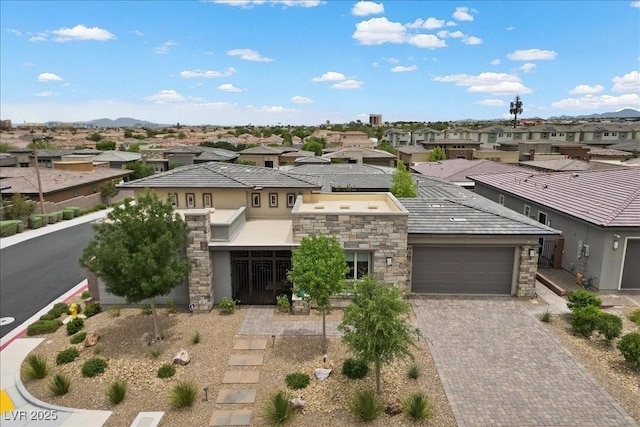 6804 Regency Stone Way, Las Vegas, NV 89148 - view of front of property featuring a residential view, stone siding, stucco siding, a garage, and decorative driveway
