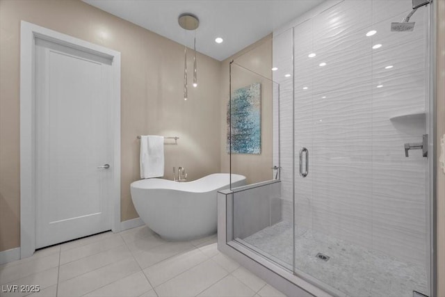 6804 Regency Stone Way, Las Vegas, NV 89148 - bathroom featuring a stall shower, a freestanding bath, tile patterned flooring, and recessed lighting