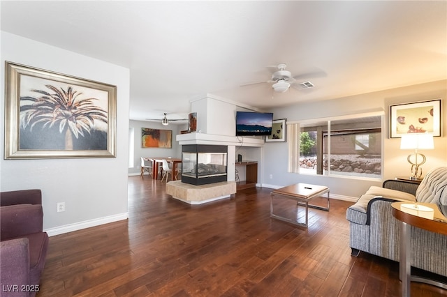 7459 Aurora Glow St, Las Vegas, NV 89139 - living area with a ceiling fan, wood finished floors, and a multi sided fireplace