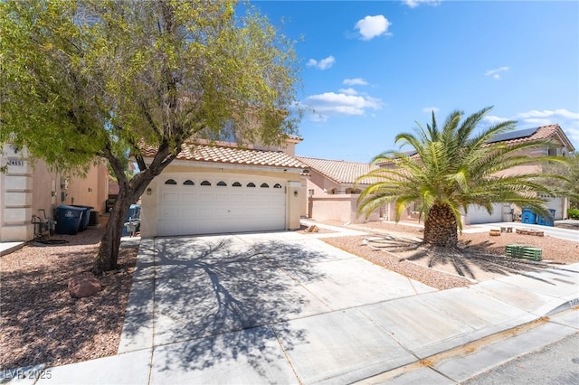 7459 Aurora Glow St, Las Vegas, NV 89139 - mediterranean / spanish home with driveway, stucco siding, a tile roof, and an attached garage