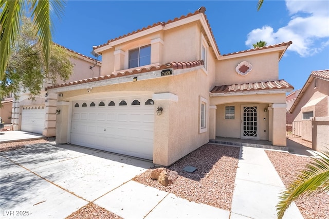 7459 Aurora Glow St, Las Vegas, NV 89139 - mediterranean / spanish-style house with a tile roof, stucco siding, a garage, and concrete driveway