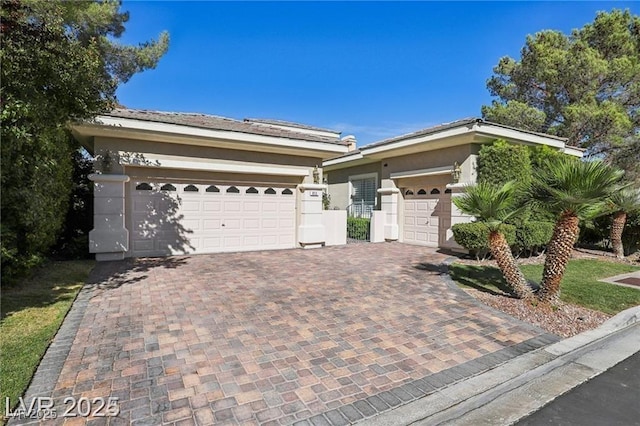 613 Pinnacle Heights Ln, Las Vegas, NV 89144 - ranch-style home with decorative driveway, stucco siding, and a garage