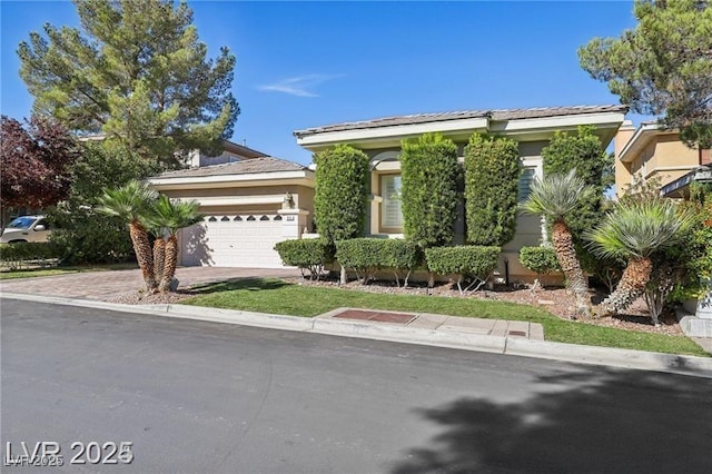 613 Pinnacle Heights Ln, Las Vegas, NV 89144 - view of front of property with an attached garage, driveway, and stucco siding