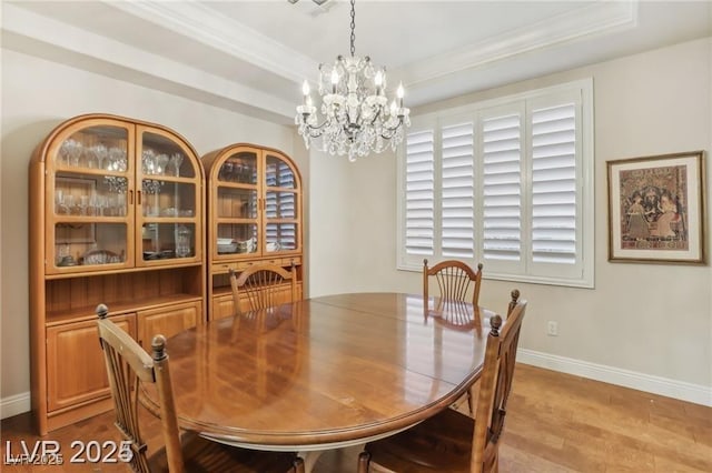 613 Pinnacle Heights Ln, Las Vegas, NV 89144 - dining room with a raised ceiling, a chandelier, wood finished floors, and crown molding