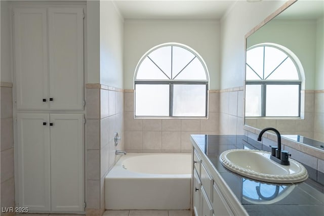 6601 W Pepperidge Way, Las Vegas, NV 89108 - full bathroom with tile walls, vanity, a bath, a wainscoted wall, and tile patterned floors