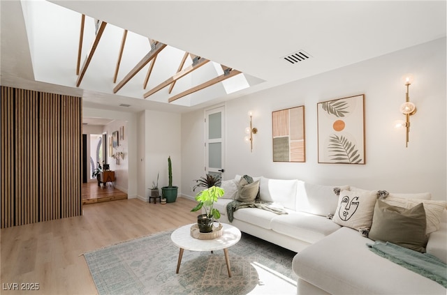 200 Stonewood Ct, Las Vegas, NV 89107 - living room with light wood finished floors and a skylight