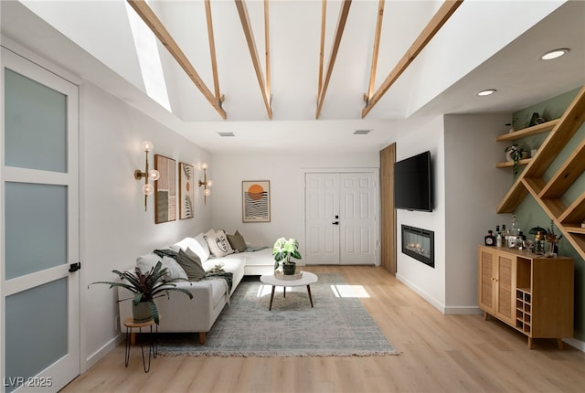 200 Stonewood Ct, Las Vegas, NV 89107 - living room featuring a glass covered fireplace, light wood-style flooring, recessed lighting, high vaulted ceiling, and beam ceiling