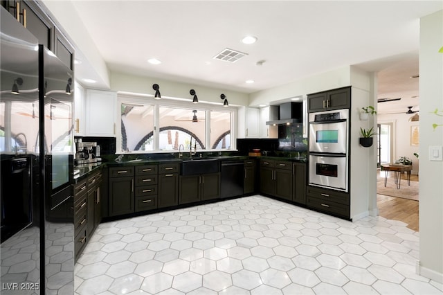 200 Stonewood Ct, Las Vegas, NV 89107 - kitchen with black appliances, wall chimney exhaust hood, dark countertops, recessed lighting, and a ceiling fan