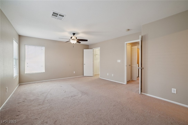 7216 Liberty Pride St, Las Vegas, NV 89148 - unfurnished bedroom featuring light carpet, a ceiling fan, and a walk in closet